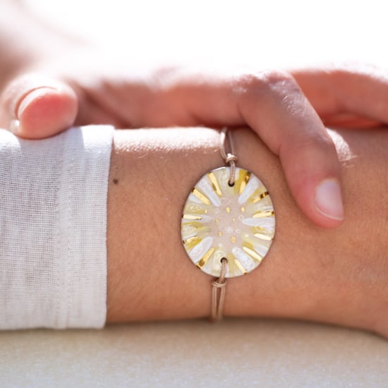 Bracelet porté au poignet en céramique jaune et blanc, doré à l'or fin - Modèle Flore Étoilée - Cala Gioia